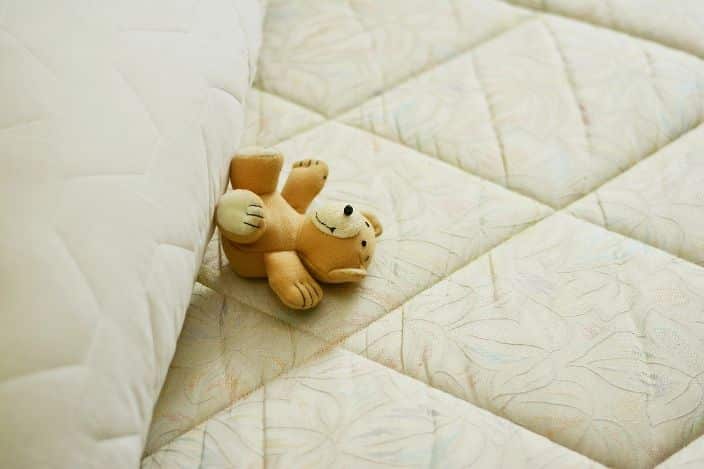 mattress and teddy bear